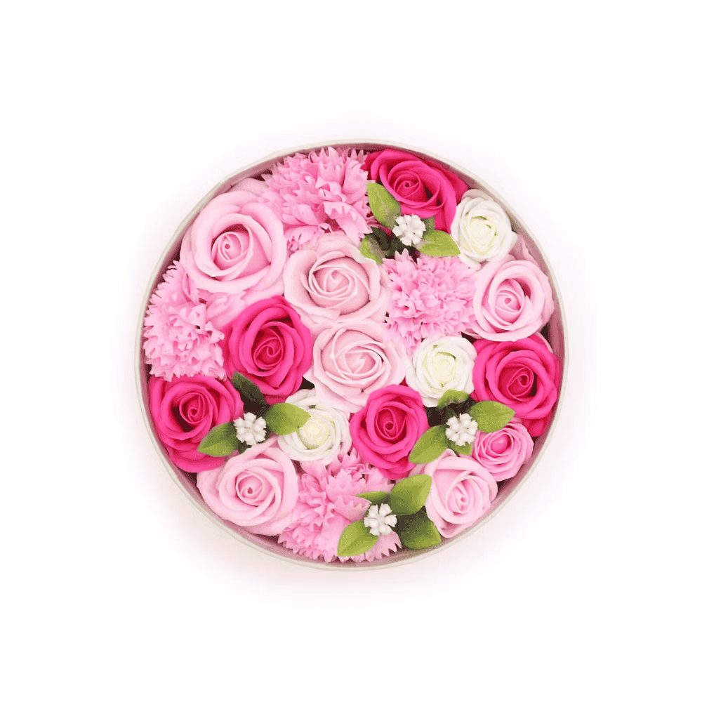 Round arrangement of pink, white, and green soap  flowers in a box on a white background