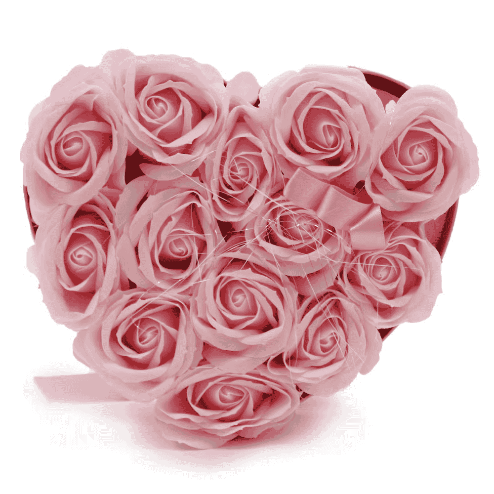 Heart-shaped box filled with pink soap roses on a white background