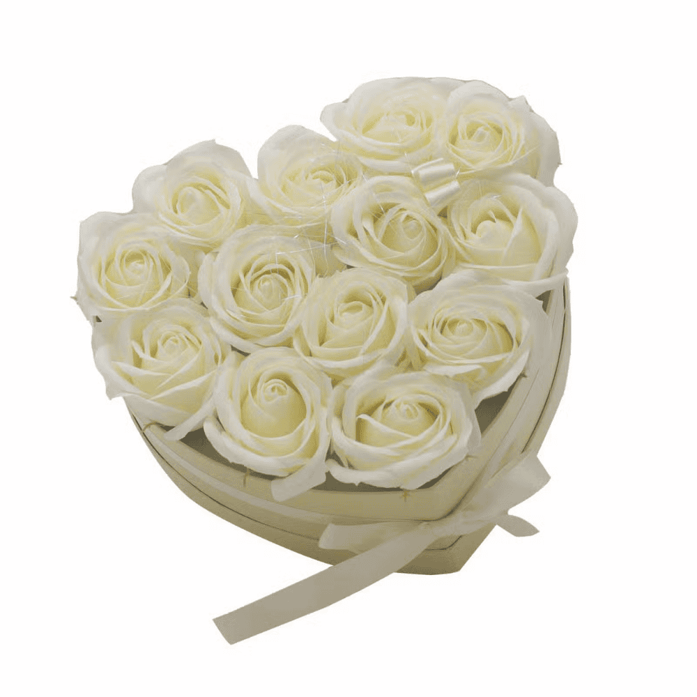 Heart-shaped box filled with white soap roses on a white background