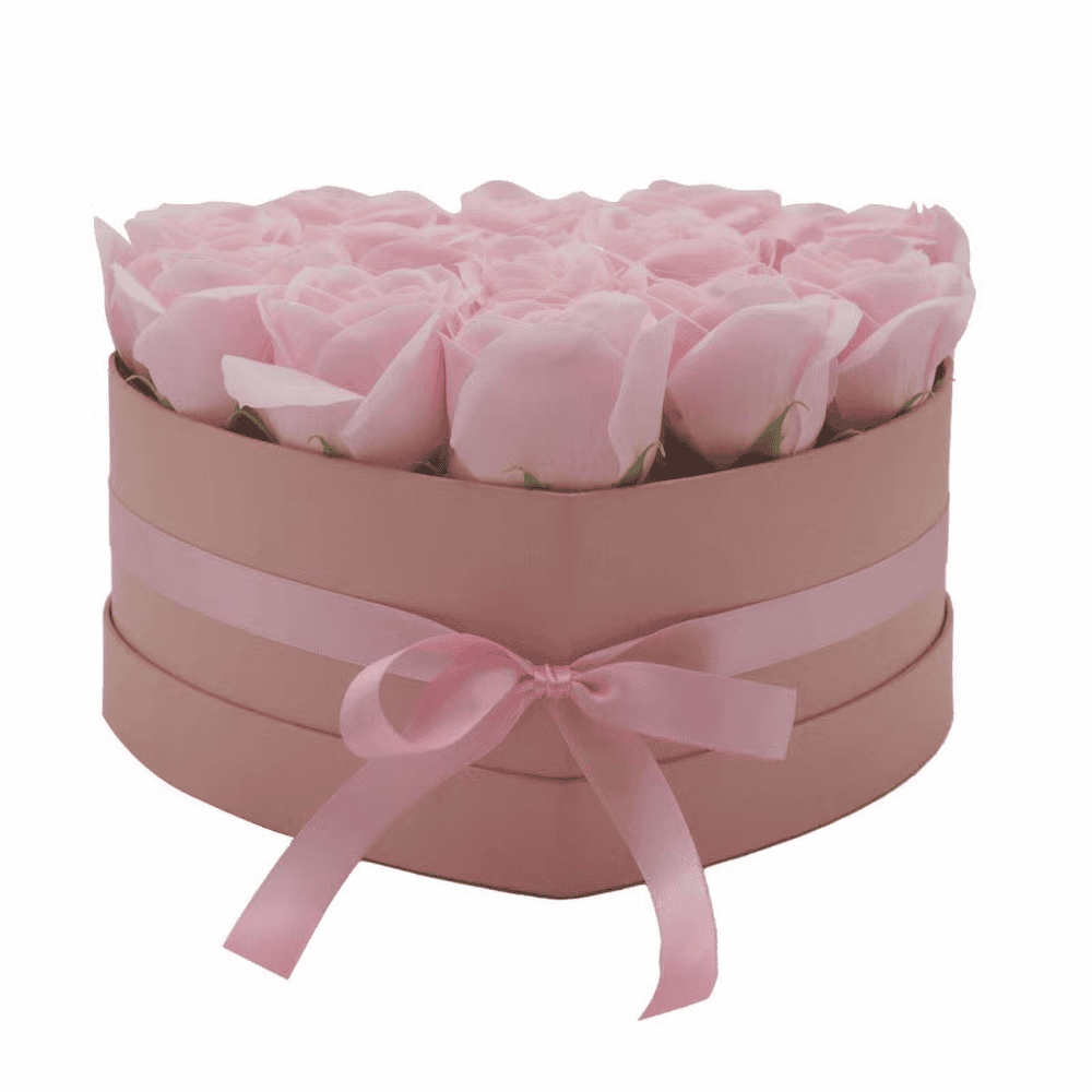 Pink soap roses in a heart box with a pink ribbon on a white background
