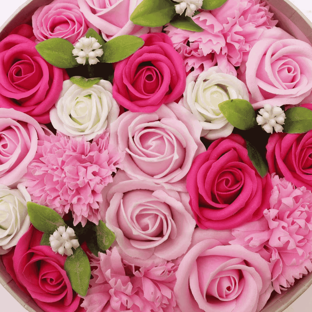 Heart-shaped box filled with pink, white, and red soap roses.