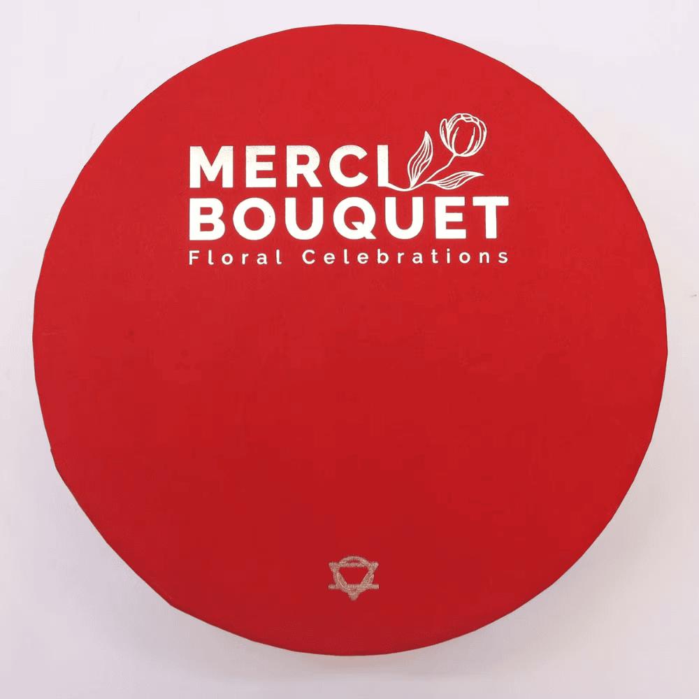 Red circular mat with 'MERCI BOUQUET Floral Celebrations' logo on a white background