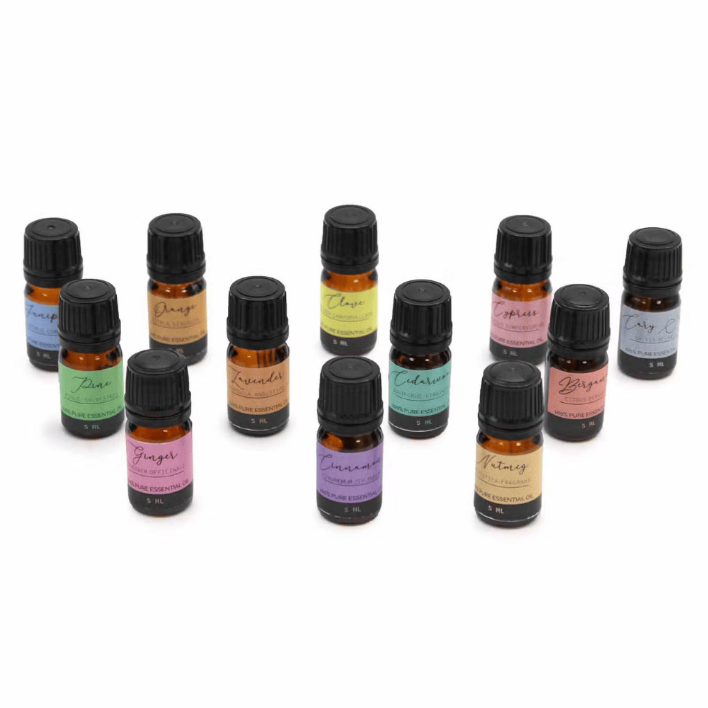 Set of small essential oil bottles with colorful labels on a white background