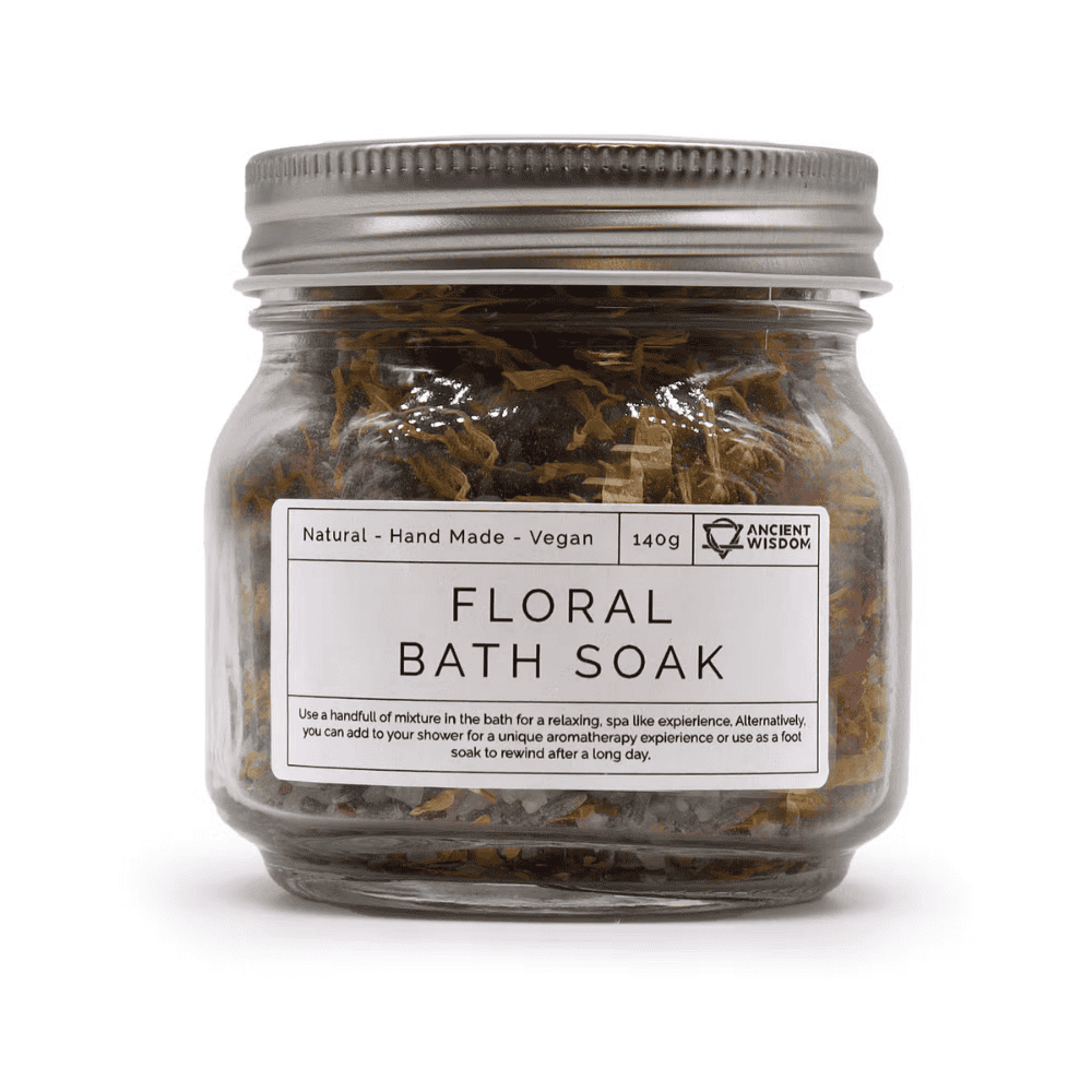 Jar of floral bath soak with a label on a white background