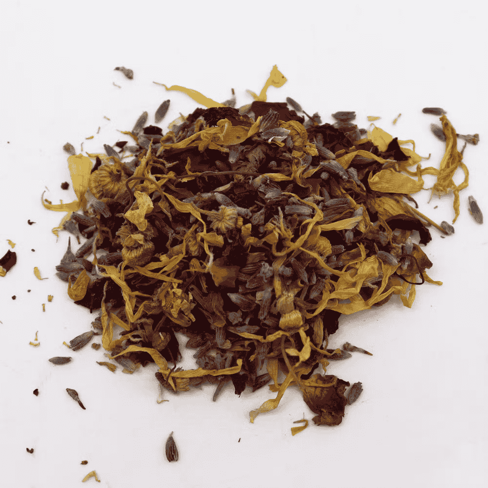 Heap of dried yellow and brown herbs on a white background