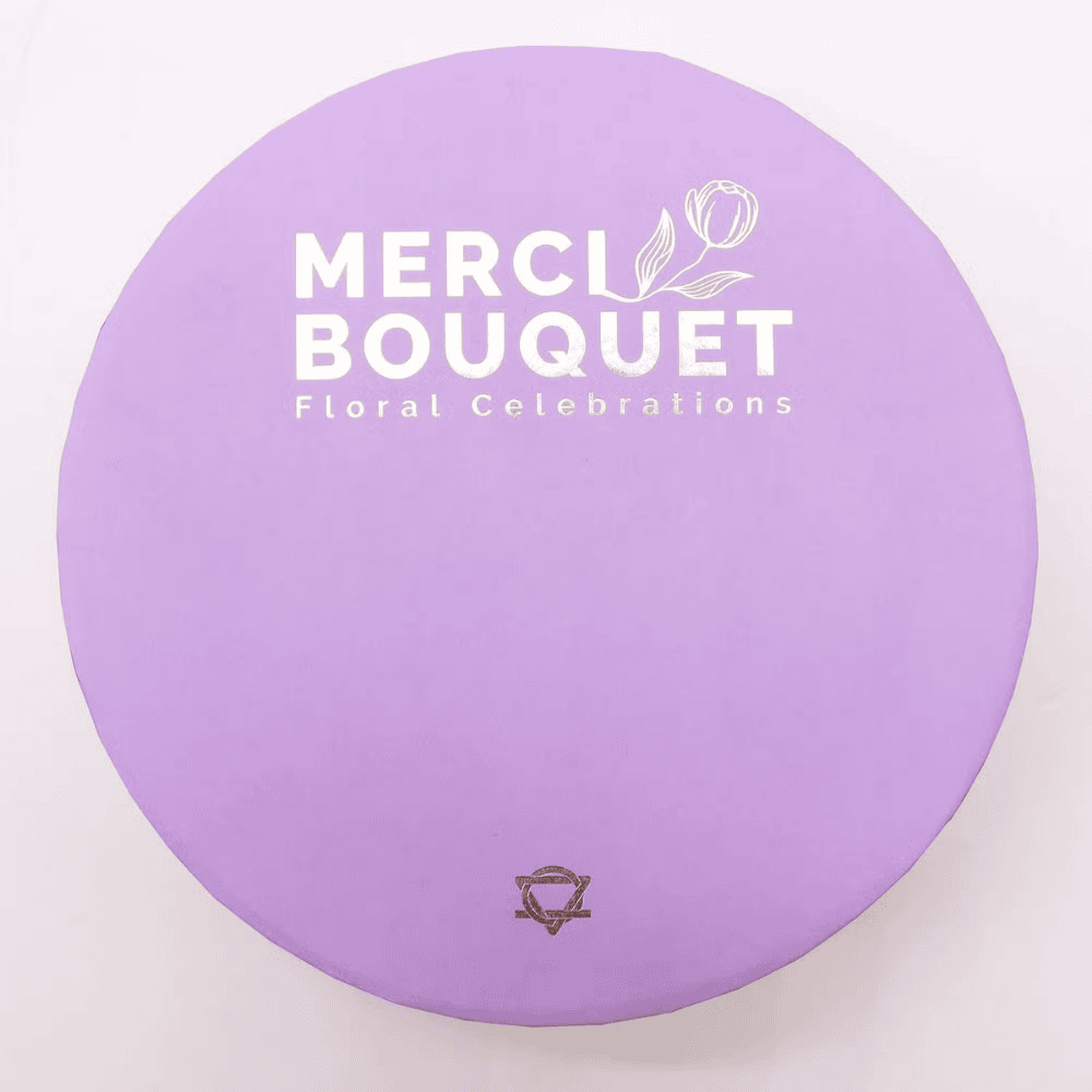 Purple circular object with 'MERCI BOUQUET Floral Celebrations' text on a white background